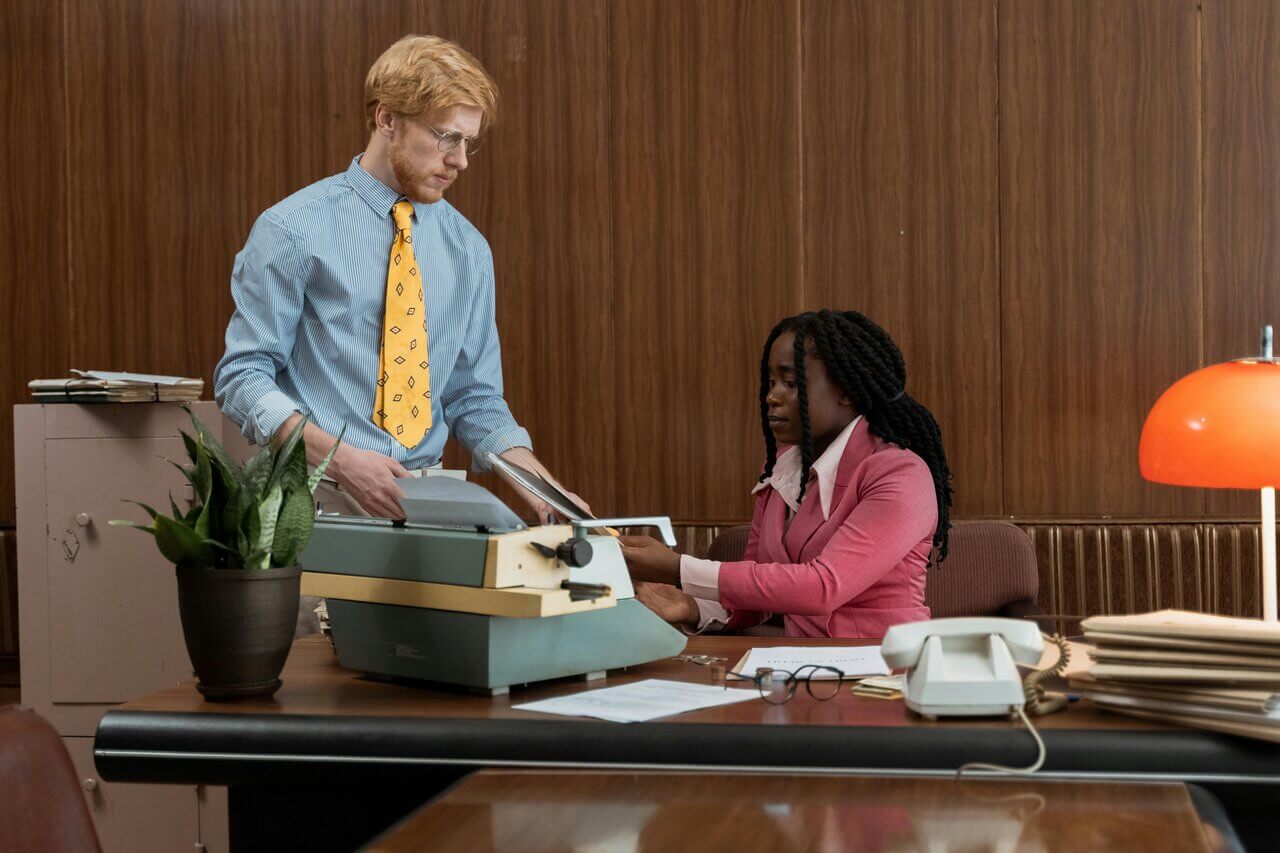 To professionals in office speaking over documents